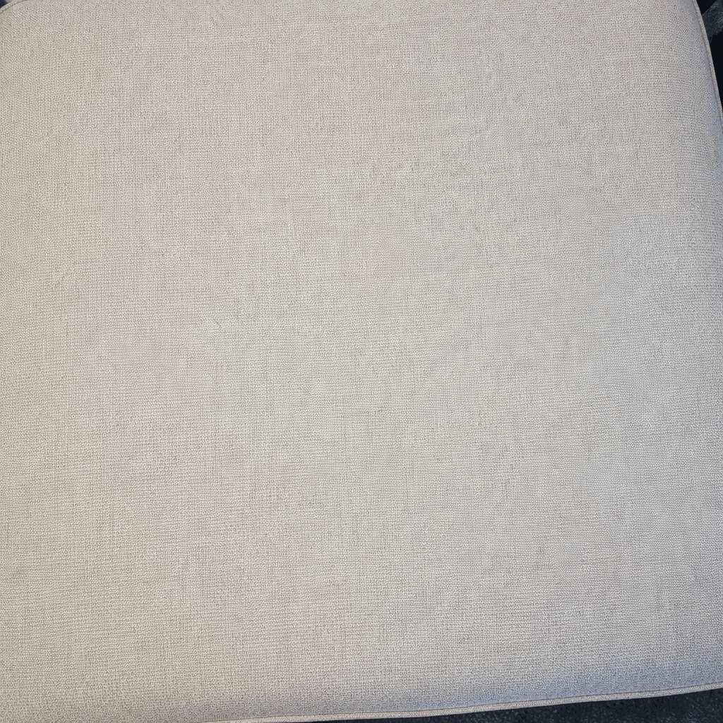 freshly cleaned grey couch in a Sugar Land TX living room after professional upholstery cleaning